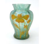 A Loetz type pale green iridescent glass vase of baluster form relief decorated with stylised
