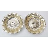 A pair of Edwardian silver dishes of flowerhead form with beaded decoration, maker SG,