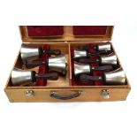 A cased set of eight chromed brass handbells,
