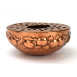 An Arts & Crafts copper posy bowl by Newlyn, with a raised fruit and leaf design, stamped, d.