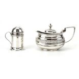An Edwardian silver mustard of boat shaped form with gadrooned border and blue glass liner,