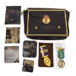 A leather Masonic bag containing apron and two jewels,