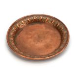 A 19th century Jugenstil copper dish embossed with repeated motifs by Carl Deffner,