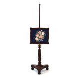 A William IV mahogany and brass mounted pole screen with a later floral embroidery,
