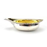 A George III silver and parcel gilt pap boat of traditional form with gadrooned rim,