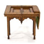 An early 20th century Moorish style marquetry and mother-of-pearl games table,