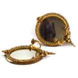A pair of late 19th century Girondelle-type gilt wall mirrors of circular form,