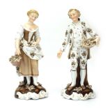 A pair of 18th century-style figures modelled as a dandy and his female companion, max h.