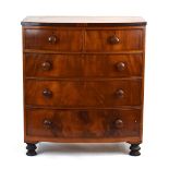 A 19th century mahogany bow fronted chest of two short and three long graduated drawers on turned