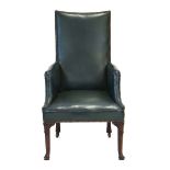 An 18th century style highback armchair upholstered in green hide,