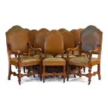 A set of twelve early 20th century oak framed and leather upholstered dining chairs,