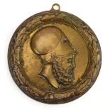 A 1916 brass wall plaque relief decorated with a Grecian warrior,