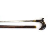 An early 20th century sword stick with a horn handle, the shaft with foliate carving,