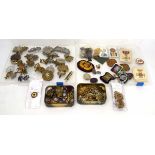 A group of assorted cap badges, buttons and silks including a Belgian Air Force cap roundel,