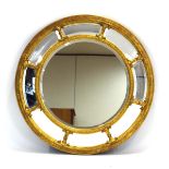 A circular wall mirror, the gilt frame enclosing nine bevelled glass plates, d.