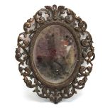A late 19th/early 20th century brown patinated wall mirror of foliate form,
