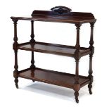 A Victorian mahogany three-tier buffet with turned and reeded supports on castors,