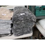 Stack of dark grey bath mats