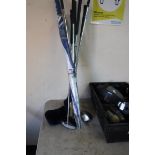 Selection of golf clubs and golf umbrella