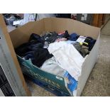 Shallow pallet box containing used clothing and towels