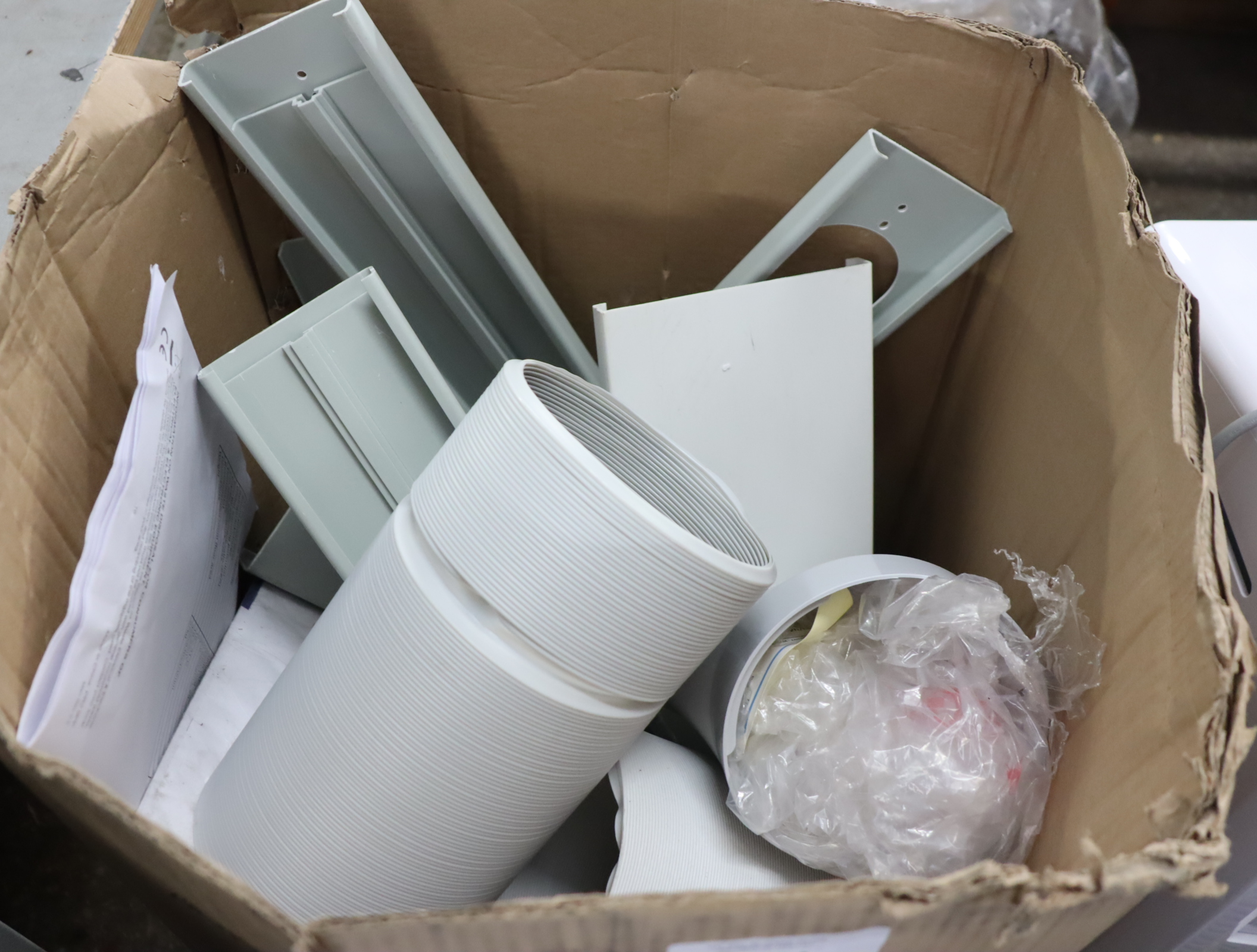 Box containing air conditioning parts