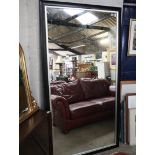 Large black and silver framed rectangular mirror