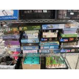 Shelf of mainly unopened jigsaw puzzles