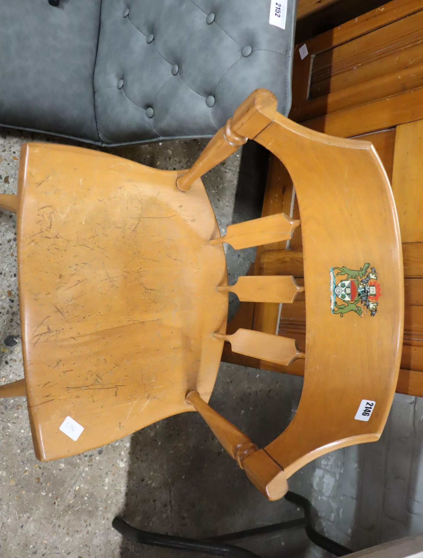 Wooden chair baring printed crest