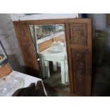 Heavily carved wooden framed mirrored panel