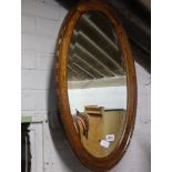 Oval oak framed and bevelled wall mirror