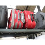 2 red wheeled luggage cases with combination locks