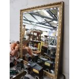 Large rectangular gilt framed and bevelled wall mirror
