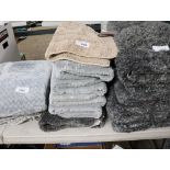 Stack of grey and beige bath mats