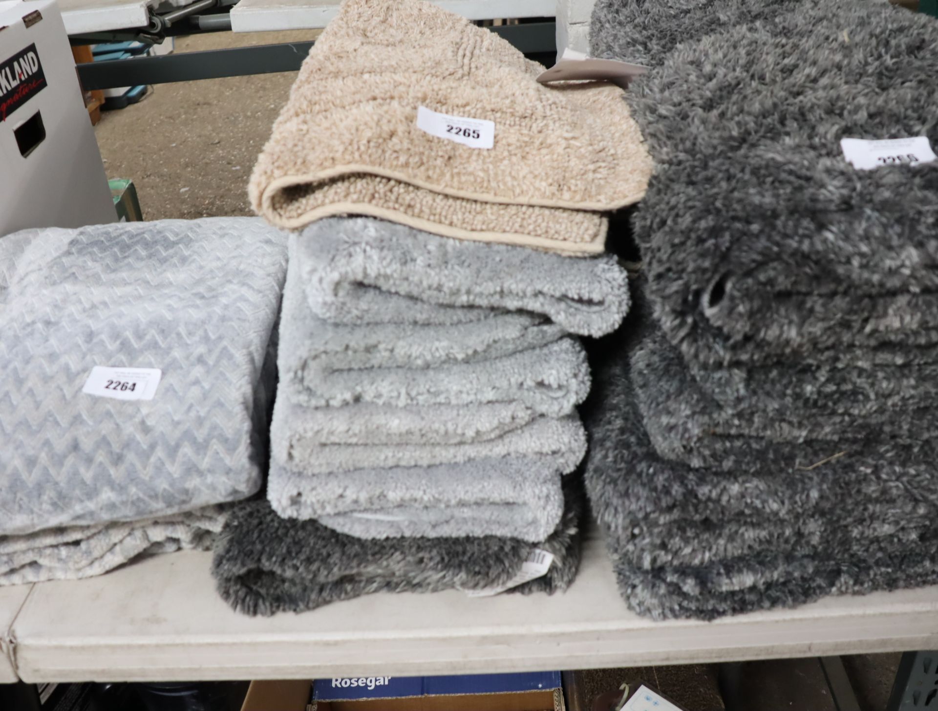 Stack of grey and beige bath mats