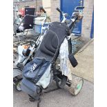 Black 2 wheel golf trolley with quantity of mixed branded golf clubs