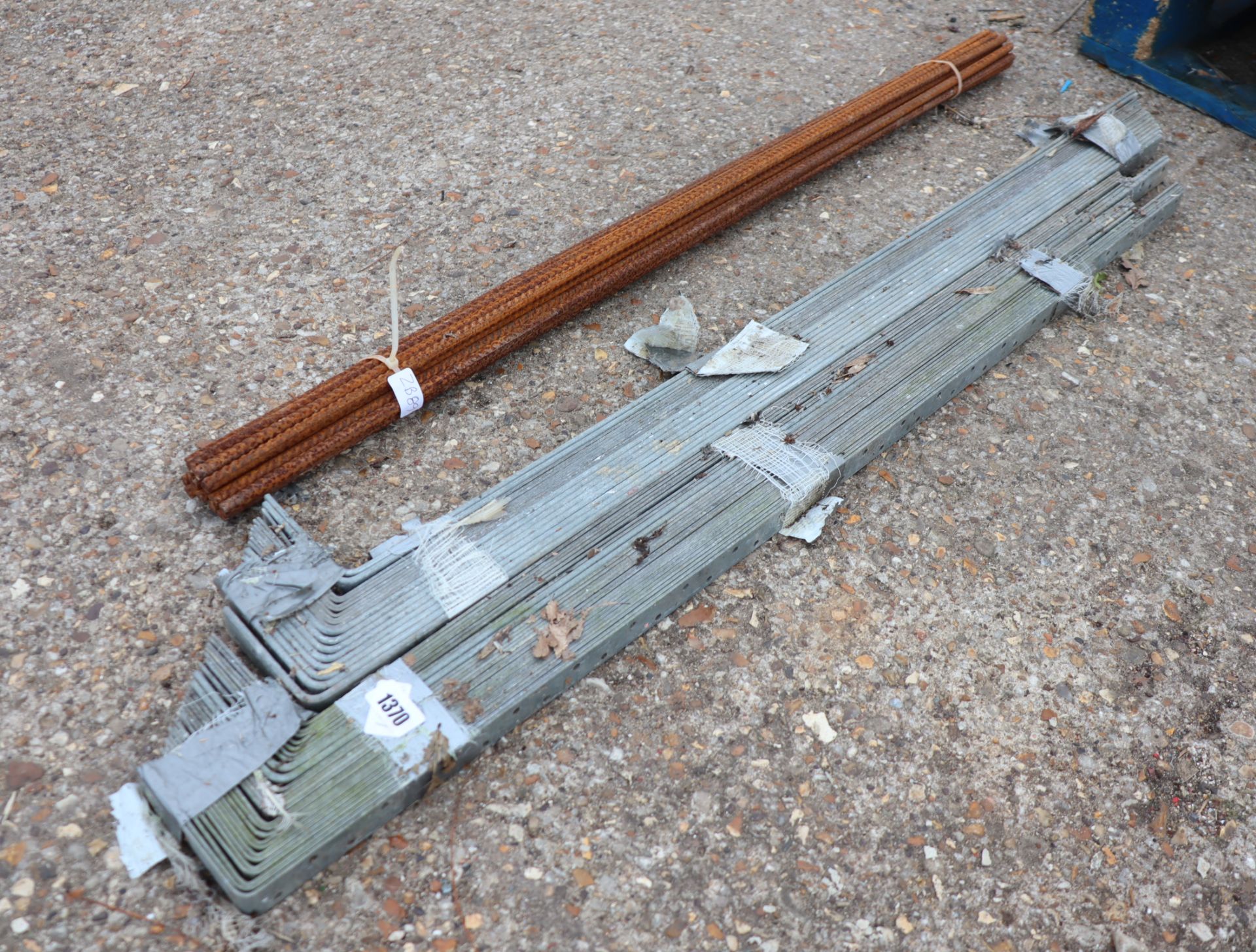 Bundle of rebar with 2 bundles of roofing straps