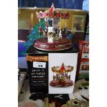 1 boxed and 1 unboxed 24cm LED lit animated Christmas carousels