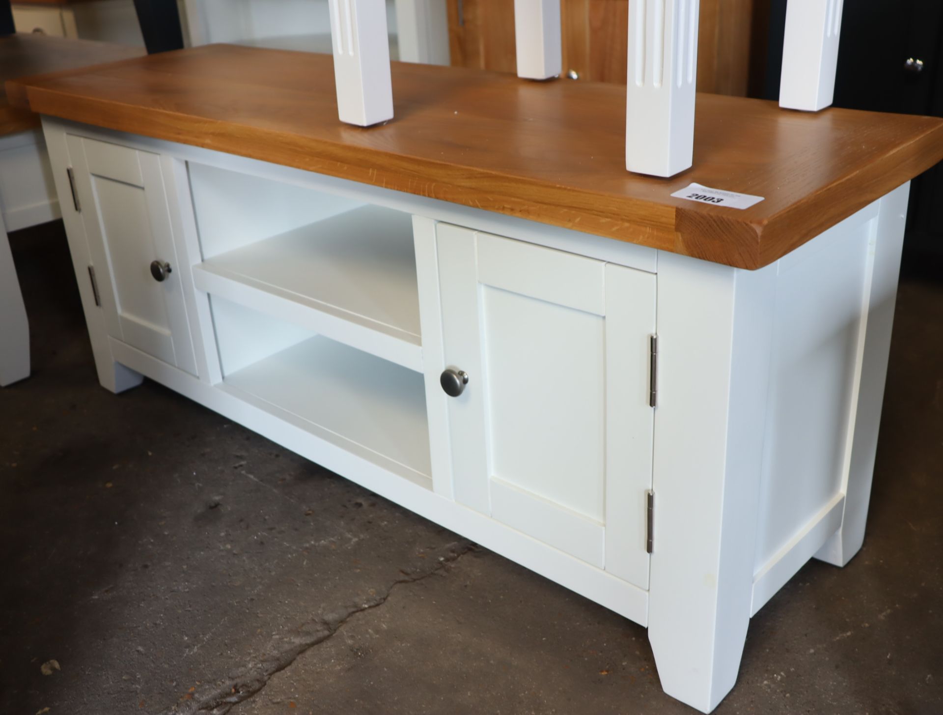 Off-white entertainment stand with 2 small cupboards and oak surface