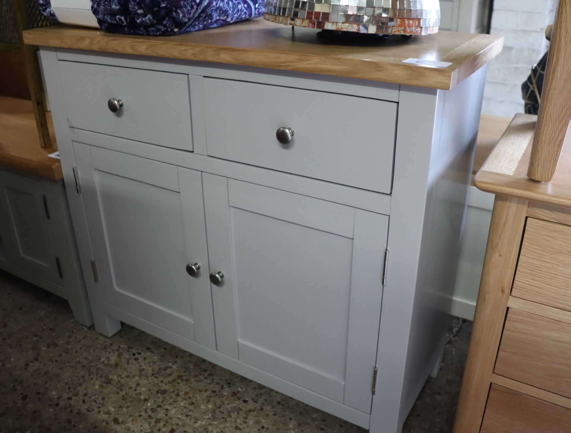 Light grey mini sideboard with 2 drawers, 2 cupboards and oak surface