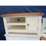 Off-white entertainment stand with single door cupboard and oak surface
