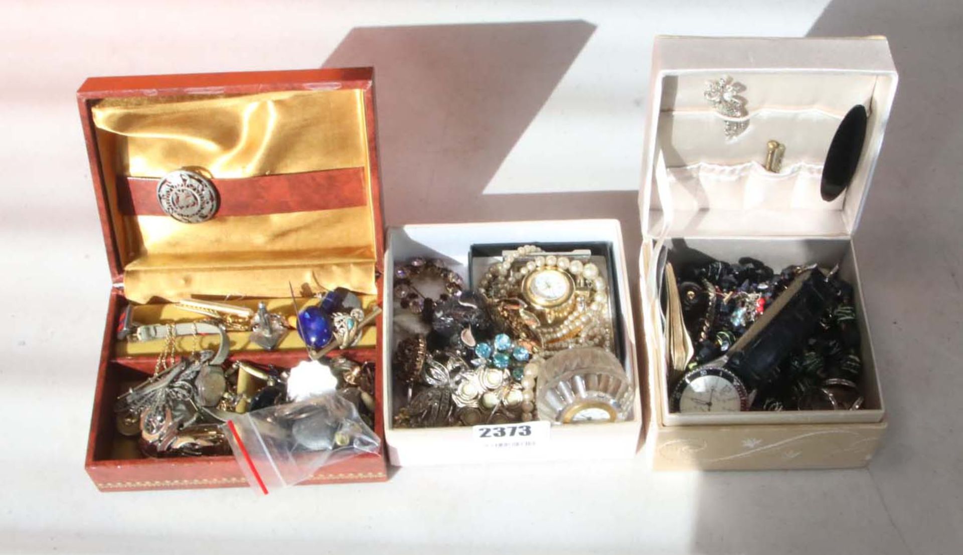 Three boxes containing various costume jewellery