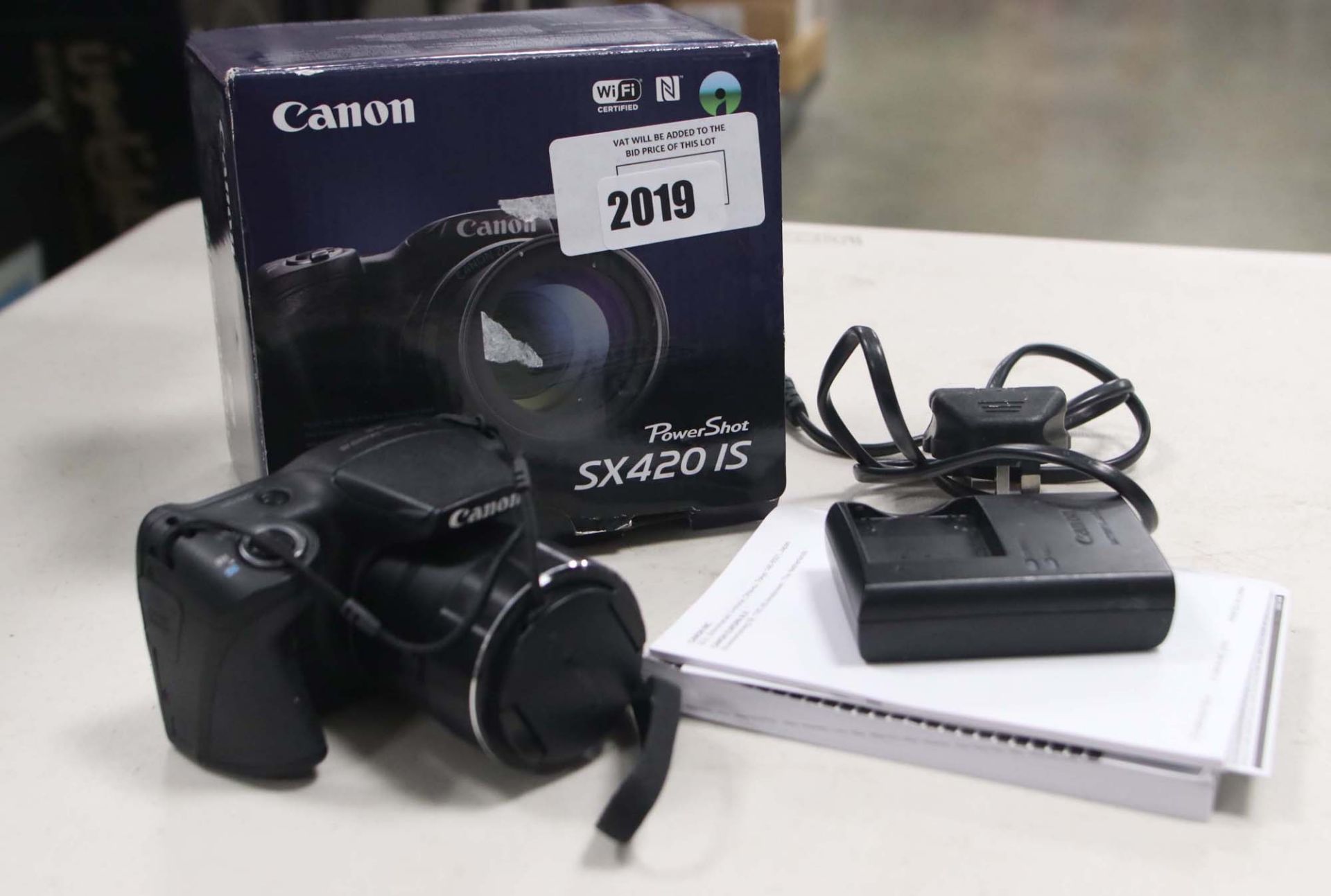 Canon PowerShot SX420IS camera with battery charger, battery and box