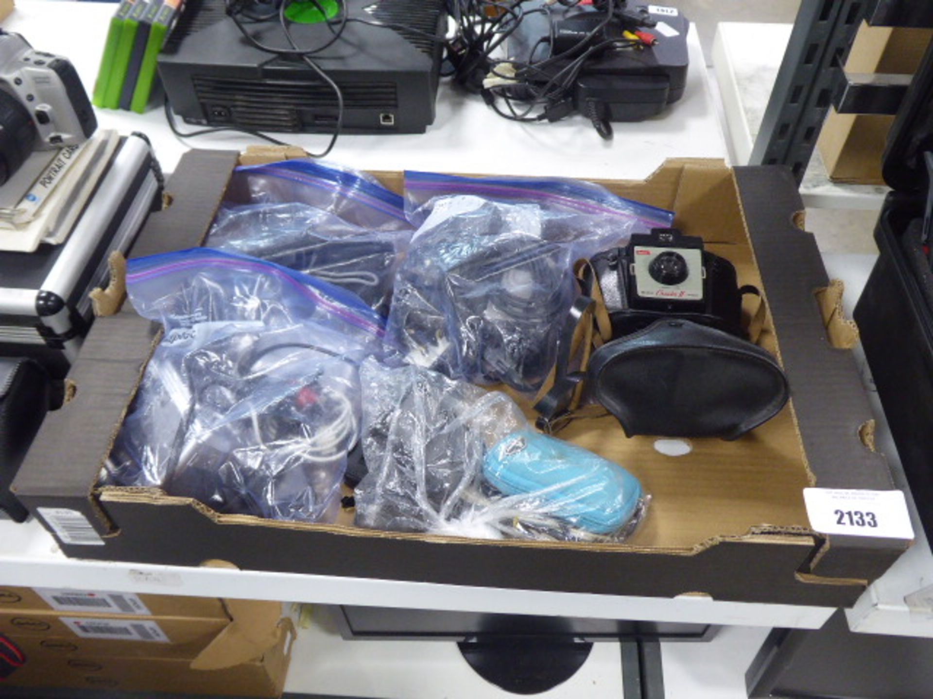 Cardboard tray with various digital camera equipment and a Kodak Cresta II box camera