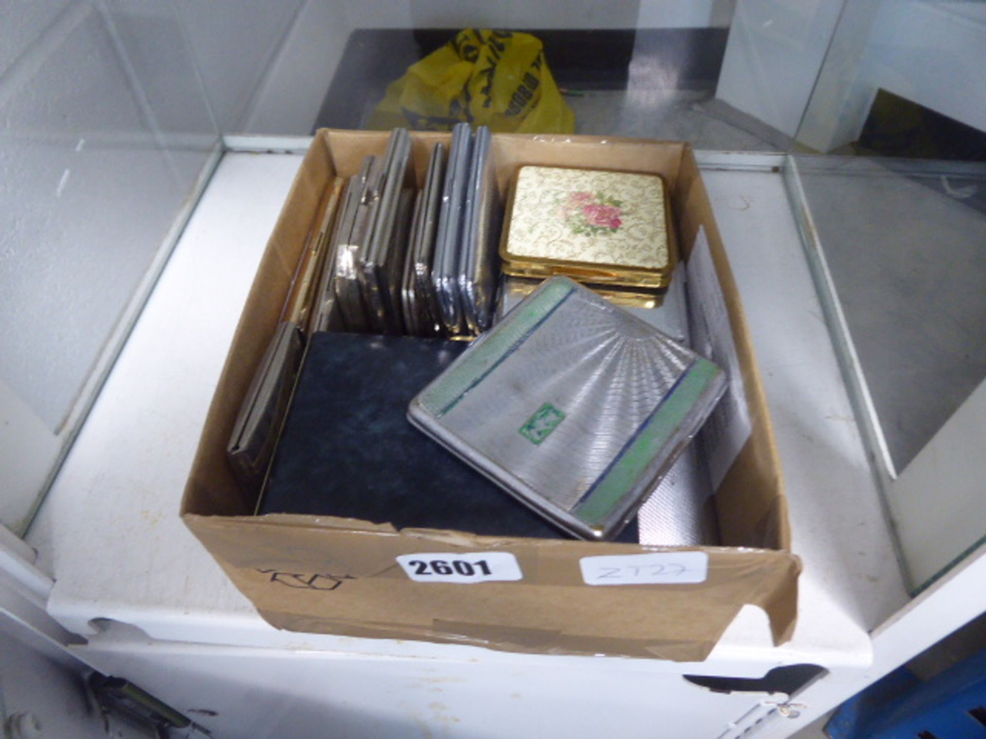 Box containing various vintage compacts