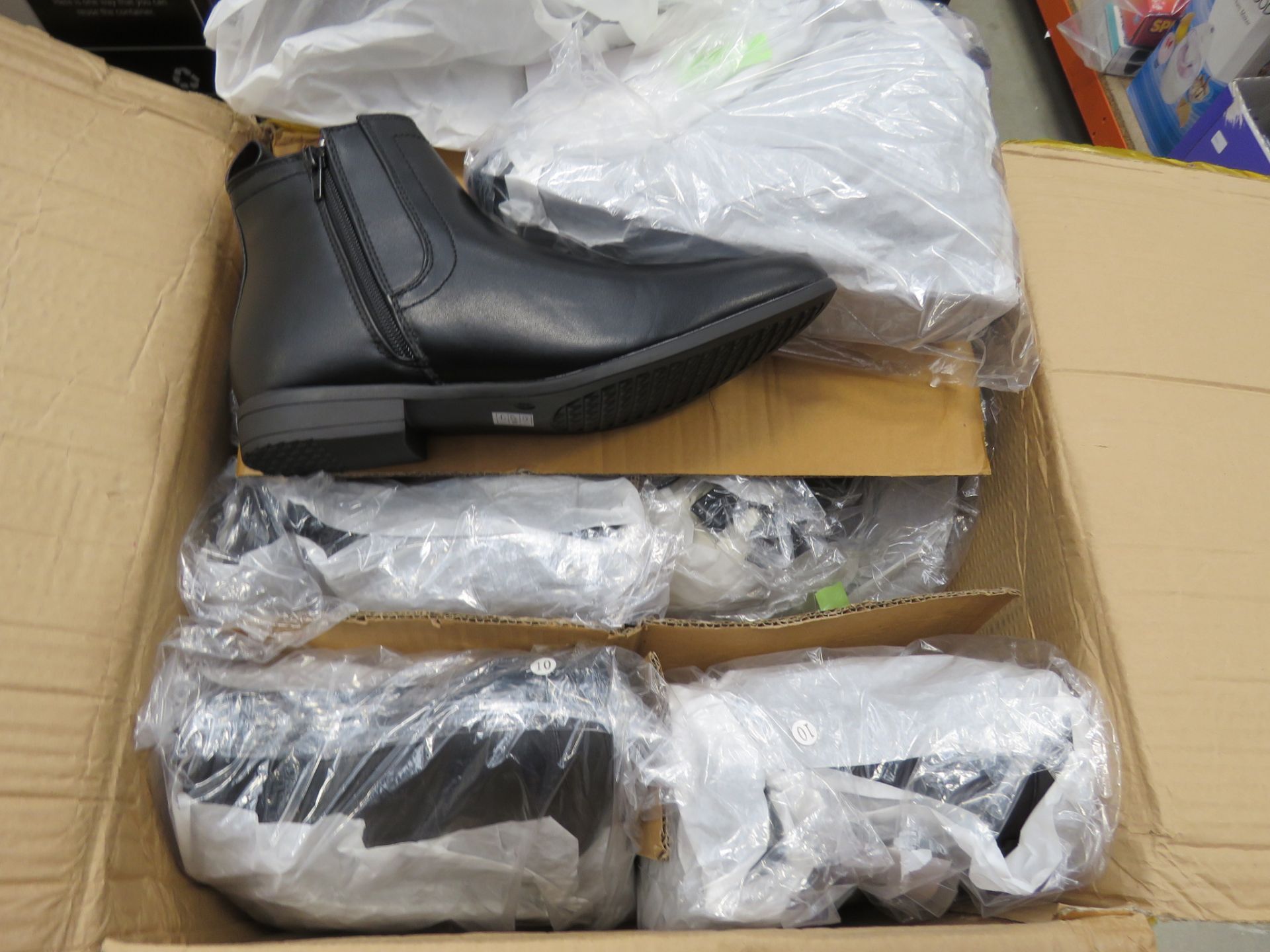 Box containing pairs of mens black boots in various sizes