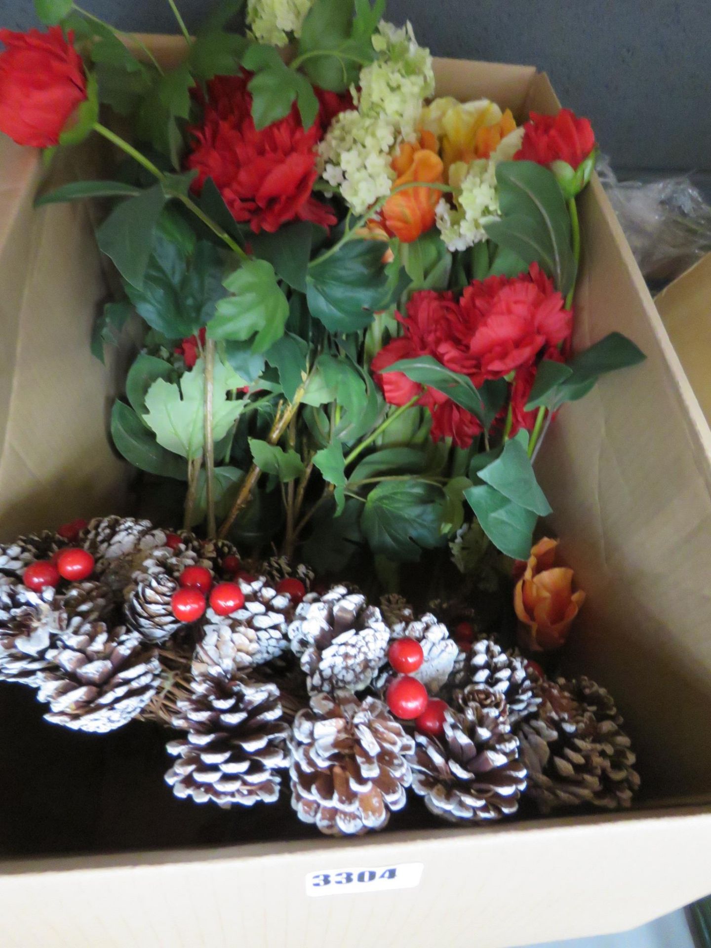 Box containing mixed artificial flowers