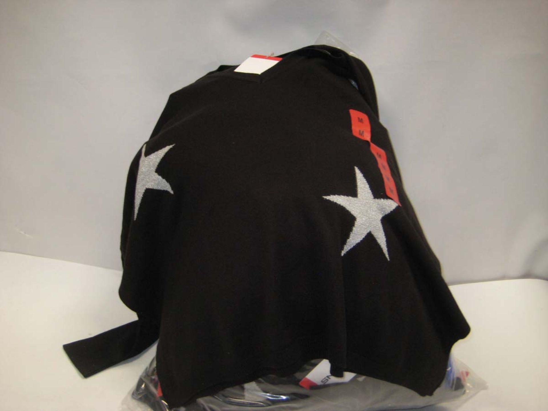 Bag containing 23 ladies DKNY jumpers with star motif in black,various sizes.