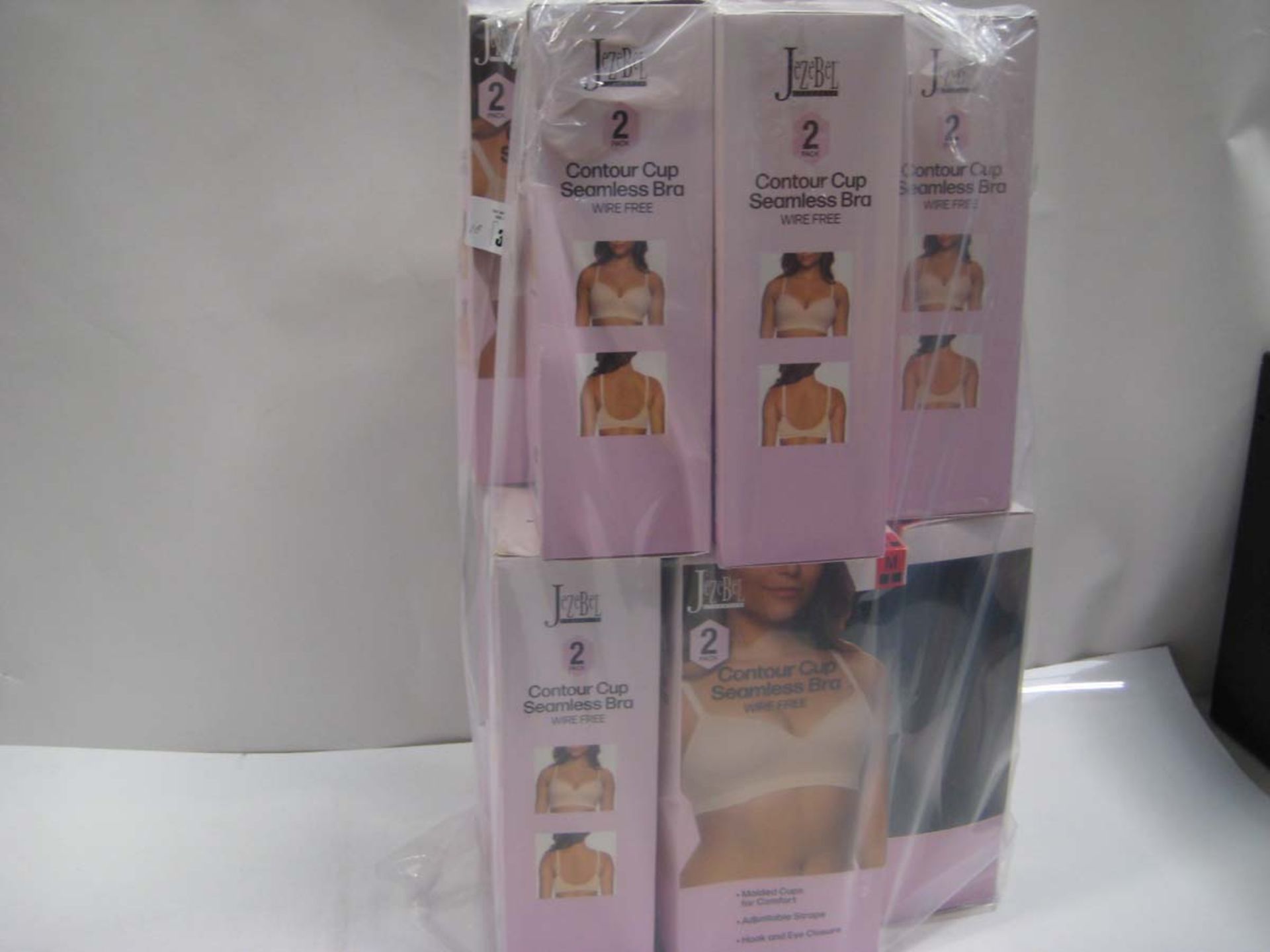 Bag containing 10 boxes of Jezebel Contour Cup Seamless Bras. Sizing small to large.