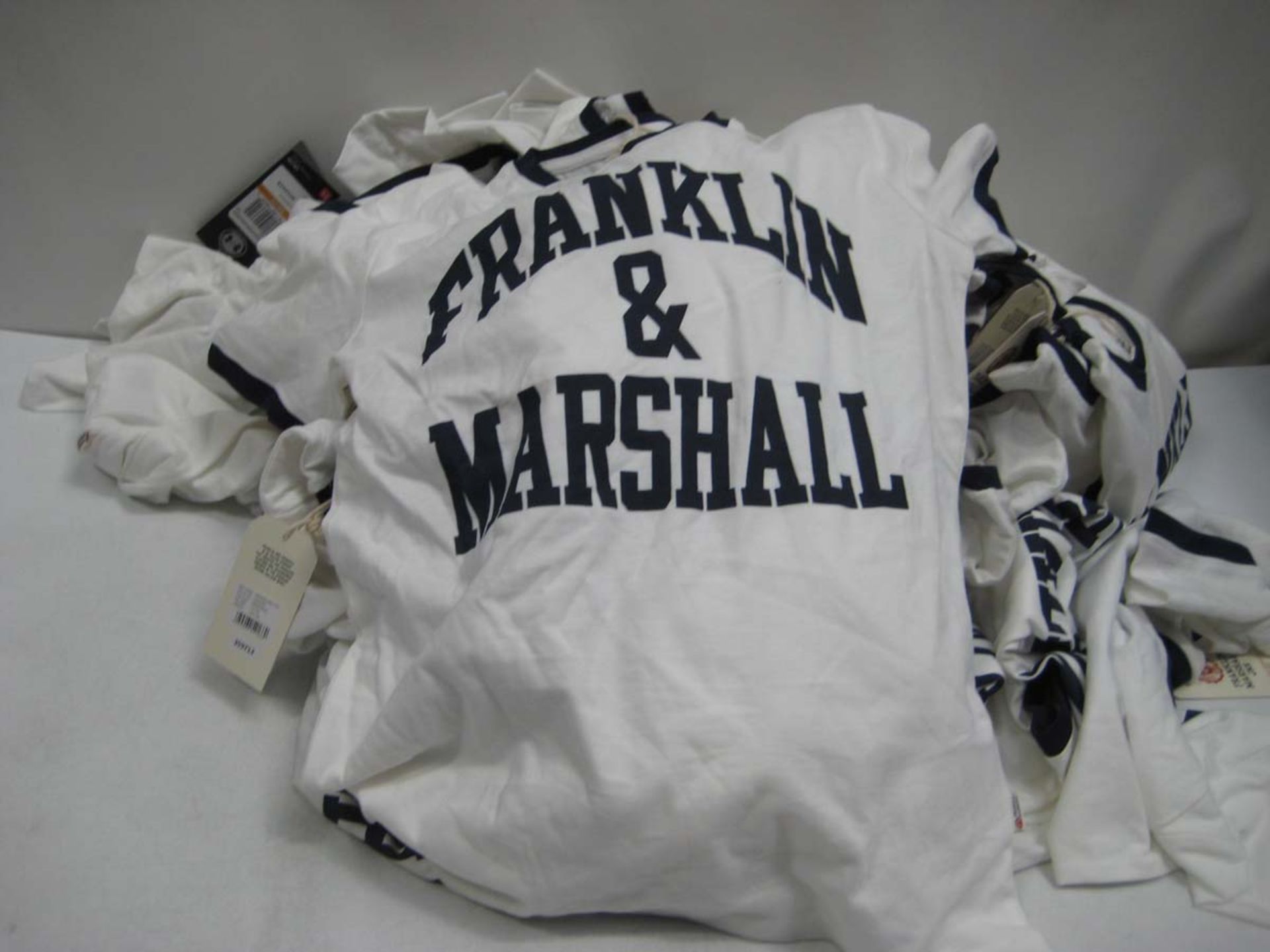 Bag containing childrens Franklin & Marshall T Shirts in white