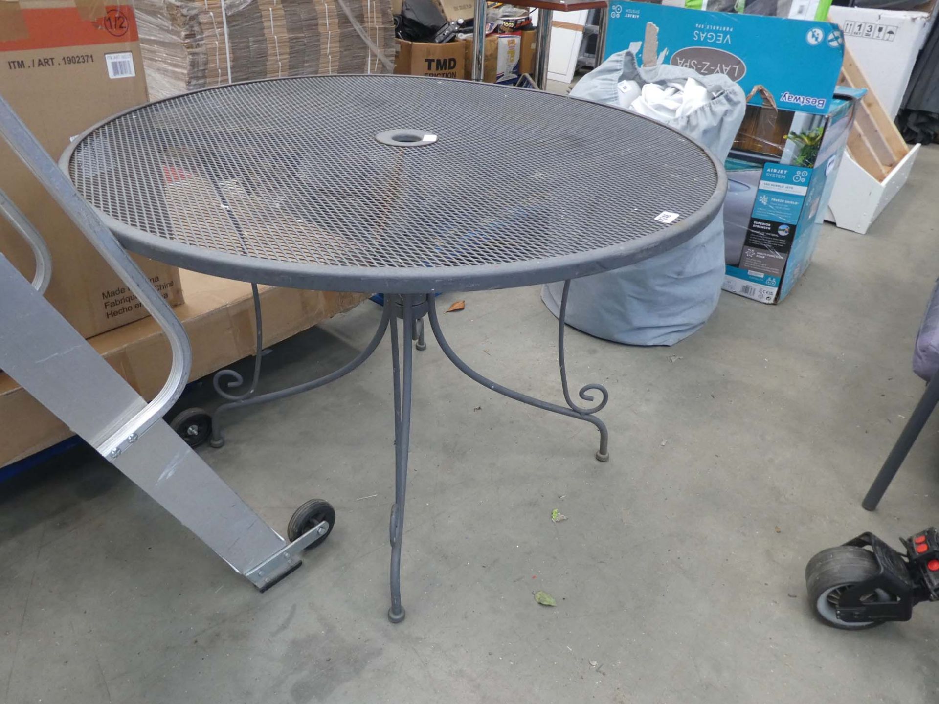 Grey circular metal garden table on matching supports
